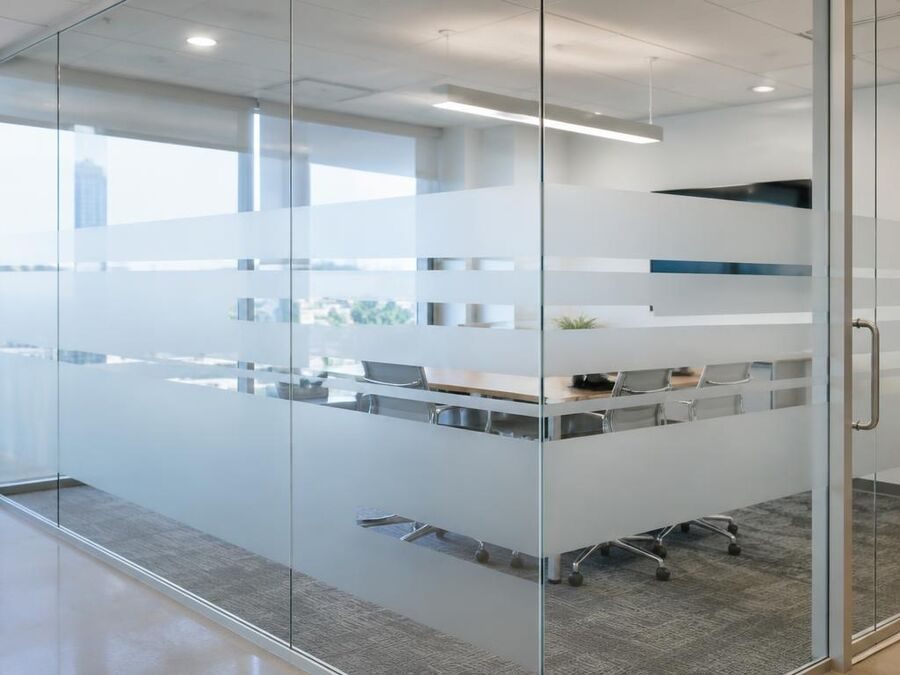 Office glass wall with frosted privacy film stripes